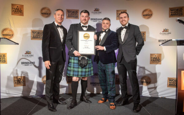 Brand ambassador receiving award from James H 2025