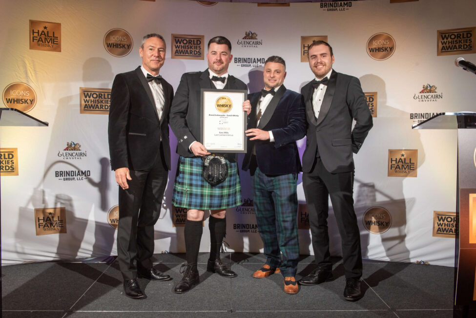 Brand ambassador receiving award from James H 2025